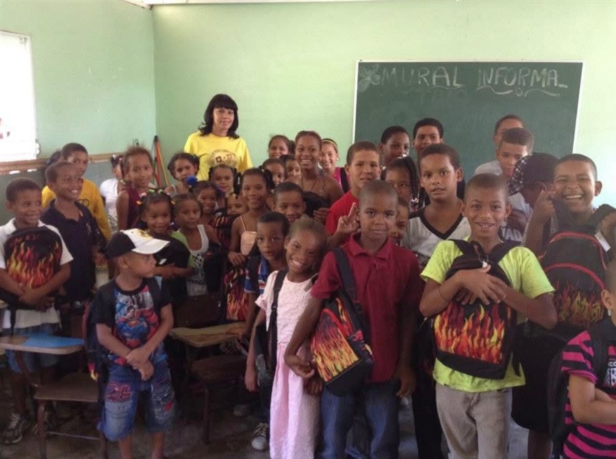 Children in their classroom holding their new Joy Packs backpacks
