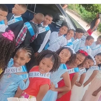 Students in sashes lined up for their school ceremony