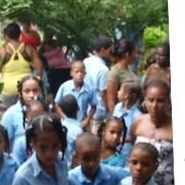 Students in blue uniforms gathered outside their school