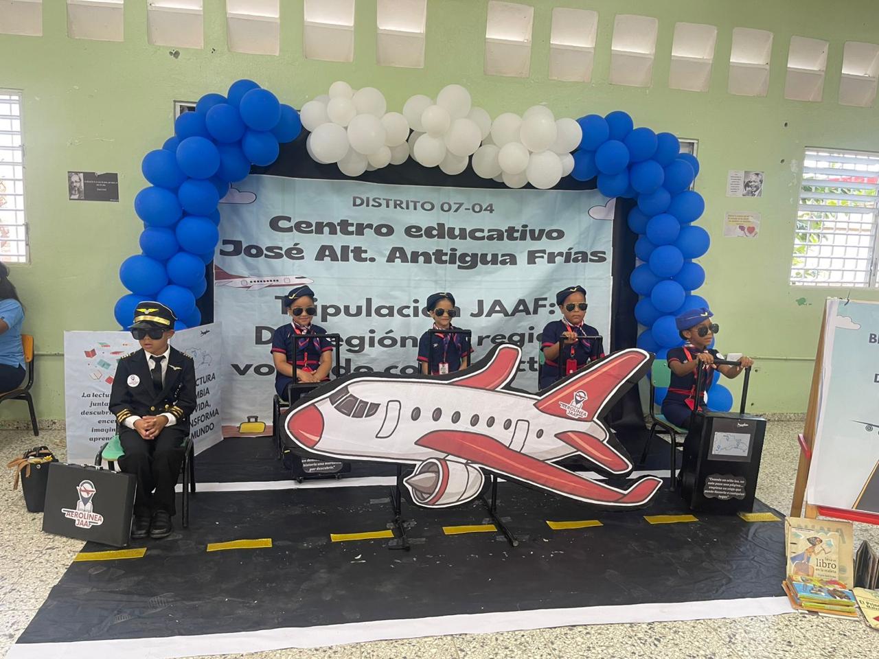 Students dressed as a flight crew with a cardboard airplane for their winning 2026 reading performance